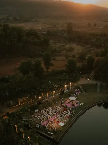 We travel wherever your story takes us. This breathtaking sunset view from a drone captures the grand scale and serene beauty of a destination wedding at Oleander Farms, setting the stage for an unforgettable ceremony by the water.