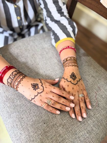 Another view of the minimal lotus mehendi, showing the delicate details on the back of the hands.