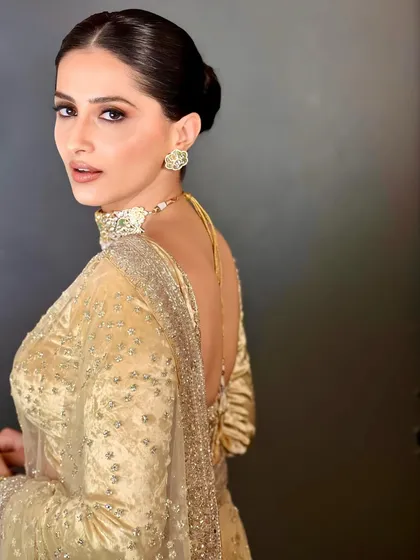 For ultimate sophistication, a sleek and polished low bun is a perfect choice. This clean hairstyle is ideal for highlighting a statement backless blouse and elegant jewelry, making it a go-to for formal evening events.