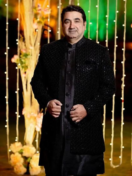 My bespoke services are for everyone. This is a custom-made black textured bandhgala-style jacket, offering a sophisticated and elegant look for a family wedding or formal event.