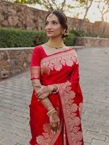 For this beautiful Bengali bride, we embraced tradition with a classic red Benarasi saree. The makeup was kept soft and radiant, with defined eyes and a traditional bindi, letting her natural grace be the focus.