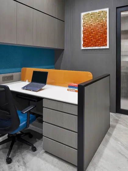 This individual workstation combines grey and orange tones for a modern look. The design includes ample drawer space and a comfortable, ergonomic chair to support a productive workday.