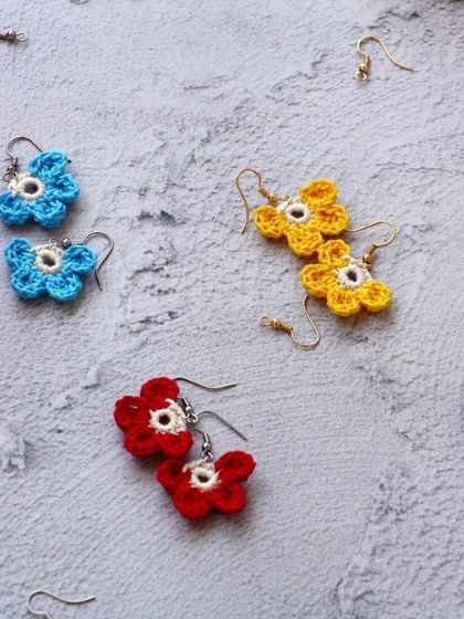 A behind-the-scenes look at my earring-making station, with several pairs of colorful flower earrings ready to be assembled.