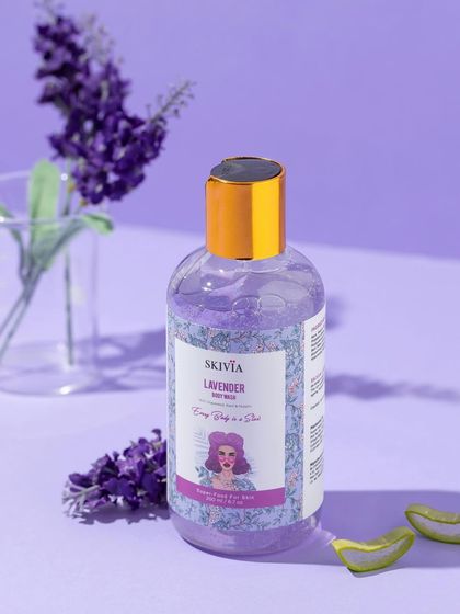 A serene, monochromatic purple setup for a lavender body wash. The use of fresh lavender and a matching background creates a calming and aromatic visual experience.