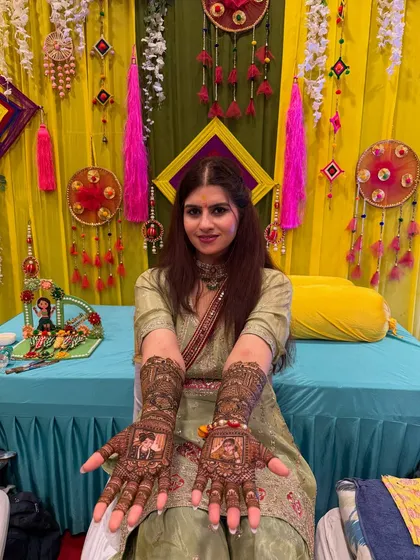 The smile of a happy bride is my biggest reward. Here is one of my beautiful brides showing off her full bridal mehndi, complete with couple portraits on her palms. It’s a joy to see my art become a part of such a happy day.