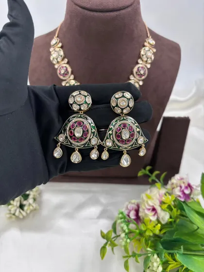 A close-up of the earrings from the meenakari set.