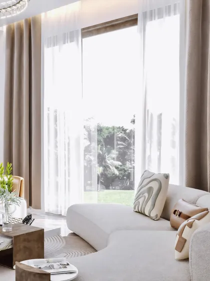 A shot focusing on the lounge area, with a large window providing ample natural light and a view.