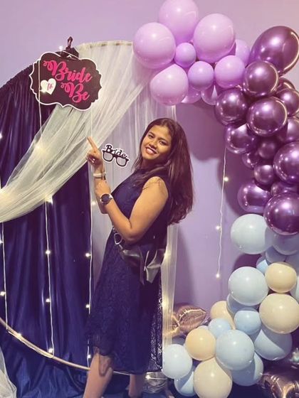 The bride-to-be pointing to her special 'Bride to Be' sign. I love adding these little personalized touches to make the celebration unique.