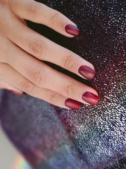 A sophisticated matte red polish, perfect for a chic and confident look.