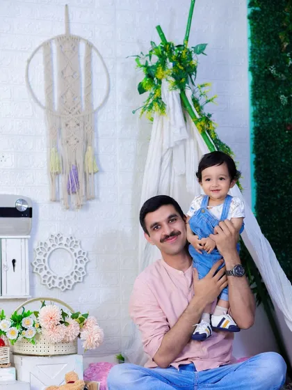 The bond between a father and his son is so special. Here, they are sharing a happy moment in our decorated tent, a perfect setting for a relaxed family photoshoot.