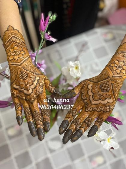 The same elegant floral design, shown with both hands together to highlight its symmetry.