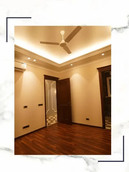 An empty room with beautiful wooden flooring and cove lighting, ready to be transformed into your dream space.