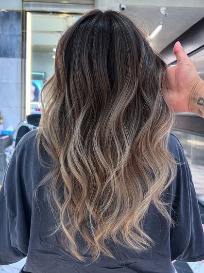 This balayage was created using Redken Shades EQ 09T and 09B to achieve these perfect cool, beige-blonde tones. The result is a sophisticated and dimensional look.