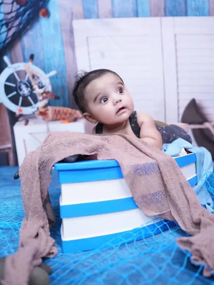 A little sailor looking out for adventure. Our ship theme is great for curious toddlers, with a nautical backdrop and a boat prop to play in.