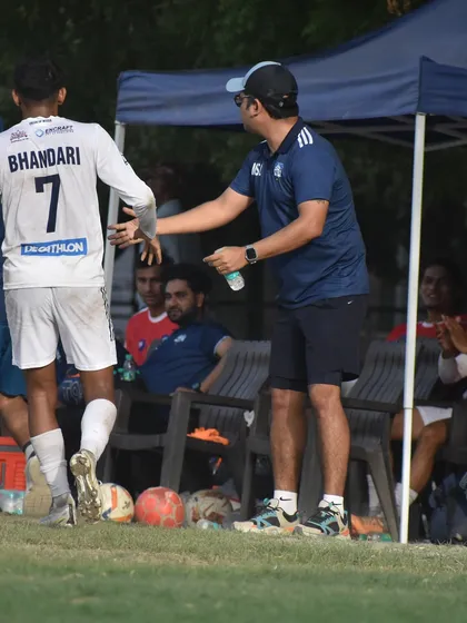 A moment of guidance from the sidelines. Our coaches are actively involved in every second of the game, providing real-time feedback to players.