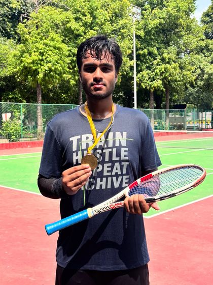 The "Train, Hustle, Repeat, Achieve" shirt says it all. Niraanjan's hard work paying off with a CBSE Cluster gold medal.