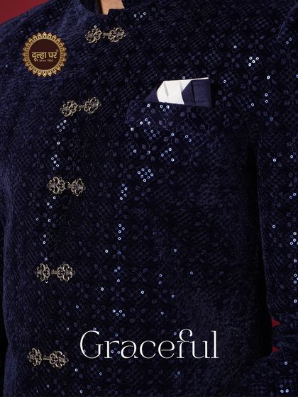 Graceful. A detailed shot of a navy blue velvet jacket, highlighting the unique buttons and sequined texture.