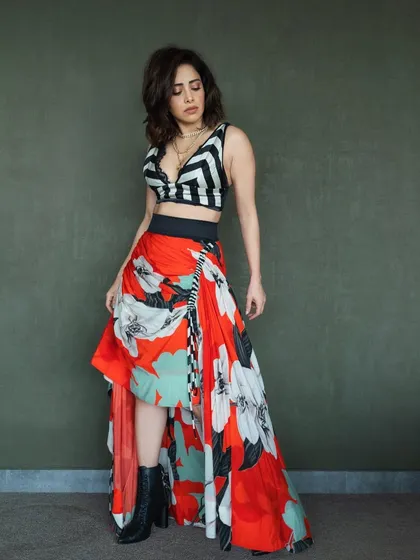 Ready for a pool party! I styled Nushrratt Bharuccha in this edgy look, pairing a bold floral skirt with a striped crop top and combat boots for a fun, high-fashion contrast.