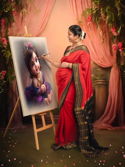 A creative and unique concept, showing the mom-to-be painting a portrait of baby Krishna, symbolizing the creation of life.