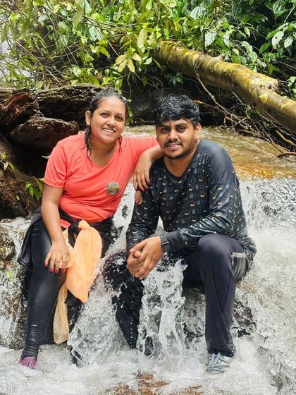 A couple enjoying a break by a stream on the Kodachadri trail.
