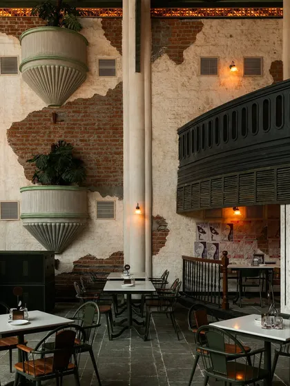 A closer look at the custom planters and the contrast between the exposed brick and smooth plaster. This textural play is essential to the space's character.