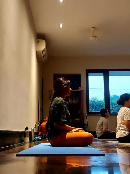A student sits in meditation, demonstrating the peaceful and focused atmosphere of our classes.