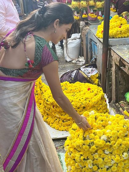 Choosing fresh flowers from the market. These beautiful blooms are used in prayers, decorations, and celebrations, adding color and fragrance to our lives.