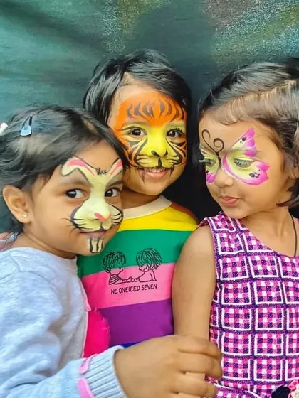 Nothing makes me happier than seeing a group of friends enjoying their new looks. Here are three different animal face paint designs, a bunny, a tiger, and a butterfly, showcasing the variety I can offer at a single kids' party.