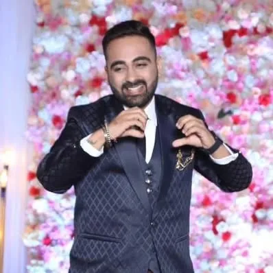 A candid moment of the groom adjusting his tie. He looks confident and ready to enjoy his reception party.