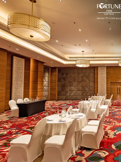 This view showcases the scale of my banquet hall, set up for a corporate event. The combination of elegant decor and practical arrangement makes it a prime venue for conferences and company-wide meetings in East Delhi.