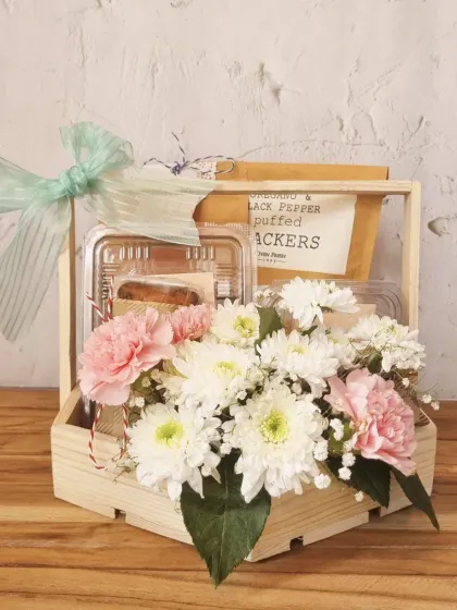 A rustic and charming Mother's Day gift, this wooden crate holds a fresh bouquet of carnations and a selection of our baked goods.