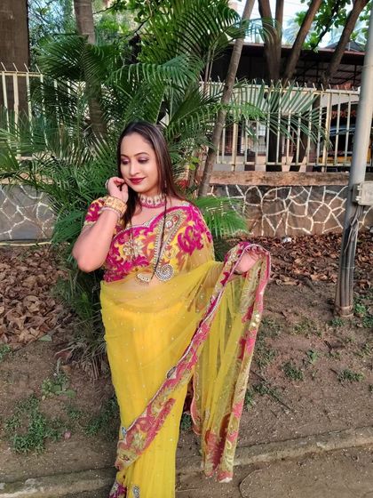 A beautiful client looking radiant in a yellow designer saree, with rentals starting at just ₹500.