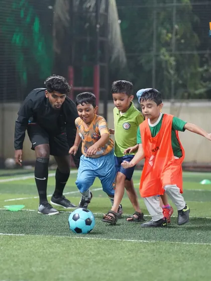A coach joins in on a drill, making it a fun and interactive learning experience for the kids.