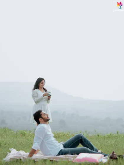 A relaxed and natural portrait from a picnic, where the groom-to-be is lying back while his partner takes a photo.