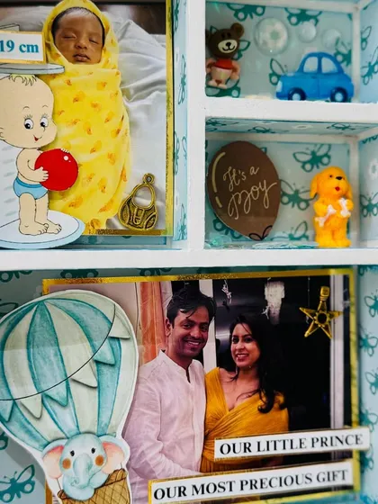 This section features a photo of the couple with their 'Little Prince', adorned with a hot air balloon cutout, symbolizing the start of a new adventure.