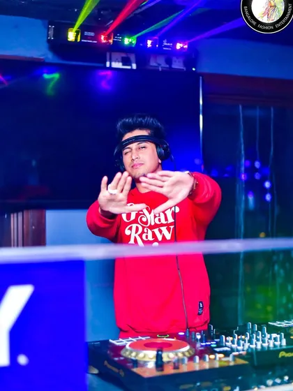 Behind the decks with the laser lights painting the club. The atmosphere is a key part of the experience I create.