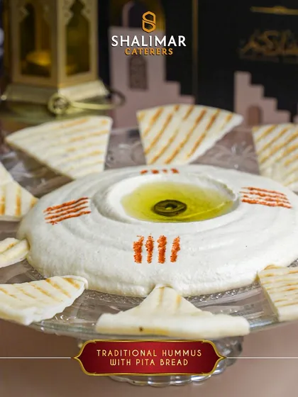 Our traditional hummus is creamy, smooth, and served with warm, grilled pita bread. It's a classic and healthy starter to begin your Iftar meal.