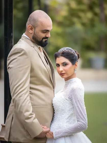 A powerful and stylish wedding portrait. The bride's direct gaze at the camera adds a touch of confidence and modern elegance to this couple's photo.