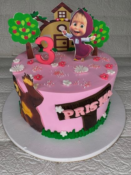 A fun Masha and the Bear theme cake for a 3rd birthday. The cake is decorated with edible images and fondant details to create a playful scene from the popular cartoon.