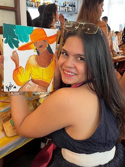 A happy participant with her summer themed portrait. The bright colors and cheerful vibe are perfect for a fun painting session.