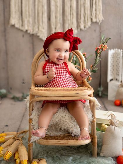 A big, happy smile from the little chef, sitting in his high chair.