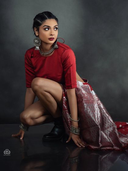 Another angle of the modern fusion saree concept, showing the interplay of the fabric, boots, and pose. The dark studio setting keeps the focus entirely on the fashion statement.