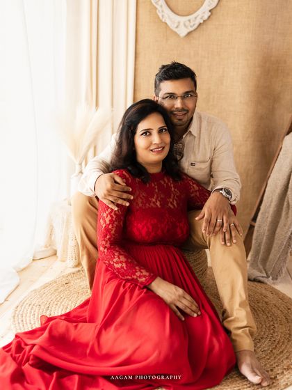 A relaxed and happy portrait of a couple during a family session. The boho-inspired setting adds a warm and casual feel.