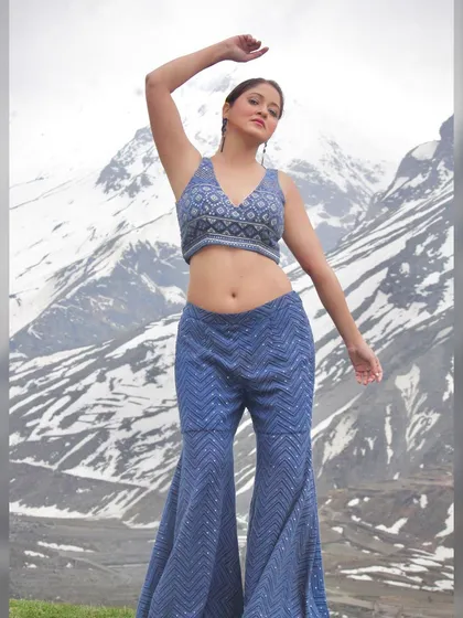 A dynamic pose showing the full outfit and its flattering silhouette.