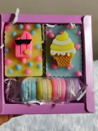 Holding the sweet-themed gift box to show its size and contents.