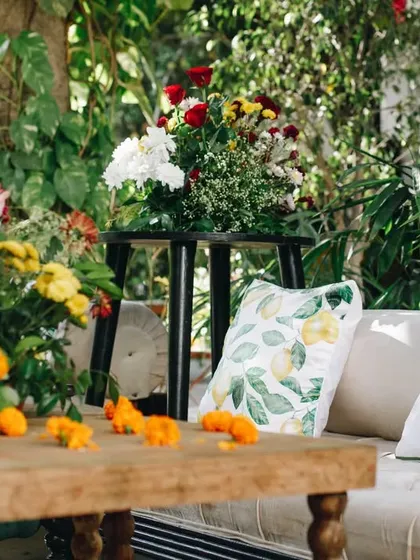A cozy seating nook at a garden Mehendi. We use comfortable furniture and beautiful, custom-printed cushions to create inviting spaces for guests to chat and relax.
