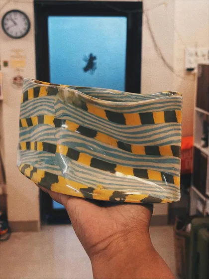 The Nerikomi technique is like painting with colored clay. This stunning piece, with its wavy lines and bold checks, was made by an advanced student. It shows how you can develop your own unique style once you master the basics.
