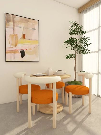 Another angle of the minimal dining design. The indoor plant and ample natural light make the space feel fresh and airy.