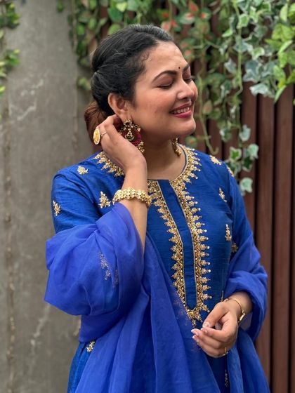 Adjusting her beautiful earring, this shot of Priyanka Barve captures a natural moment while highlighting the detailed jewelry.