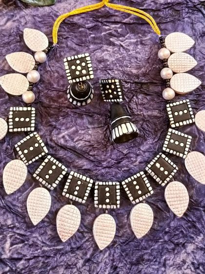 A duplicate image of the timeless black and white square and leaf necklace.